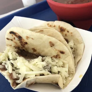 Bean and cheese tacos with side of salsa.