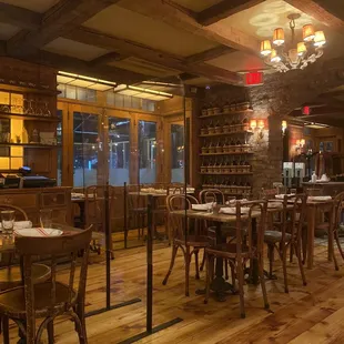 a restaurant with wooden tables and chairs