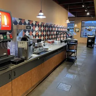 The drink and salad bar area as viewed from the restroom area entrance.