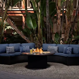 an outdoor seating area with a fire pit