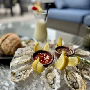 Dozen Pacific Oysters, Frozen Piña Colada, Rosemary Olive Oil Bread &amp; Caper Butter