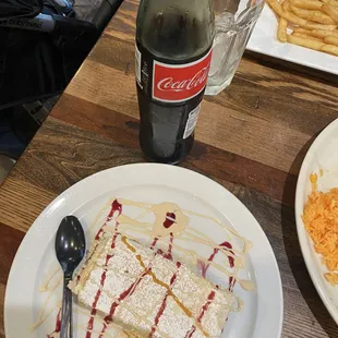 a plate of food and a bottle of coke