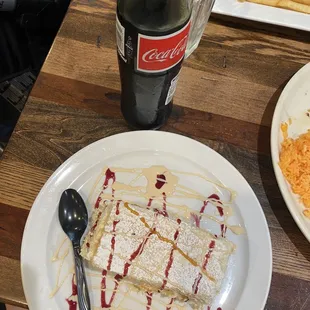 a plate of food and a bottle of coke