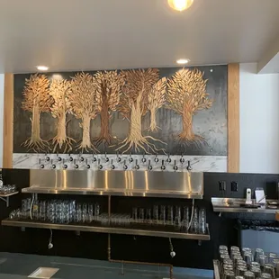 a bar with a mural on the wall