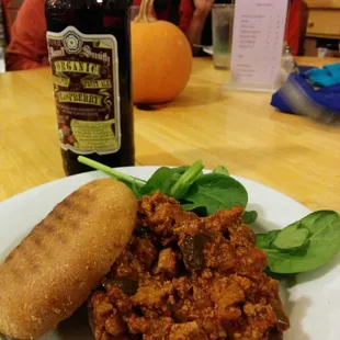 a plate of food and a bottle of beer