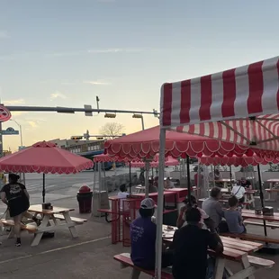 people sitting at picnic tables