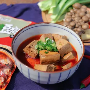 a bowl of stew and a plate of vegetables