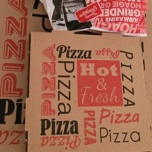 a box of pizza and a bag of pizza
