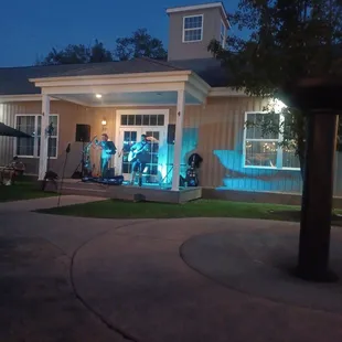 a band playing in front of a house