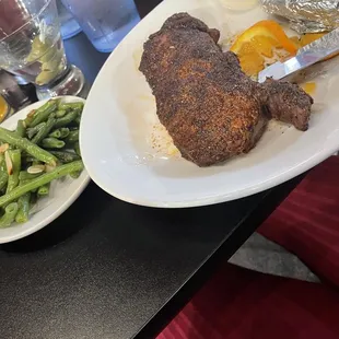 New York strip blackened with green beans and baked potato