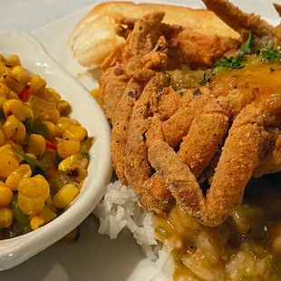 Soft shell crab on a bed of crawfish étouffée &amp; rice. Amazing!