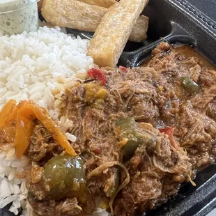 Ropa vieja with white rice, beans on the side and yuca fries with house cilantro garlic sauce