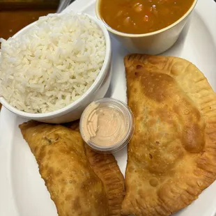Empanadas with a side of rice and beans
