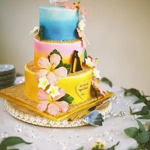 a three tiered cake decorated with flowers