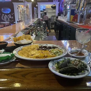 Cheese enchilada plate with side of roasted jalapeños and sour cream.