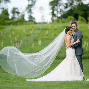 a bride and groom in a field