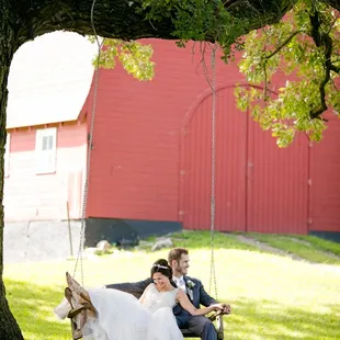 a bride and groom on a swing
