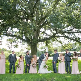 wedding party under a large tree