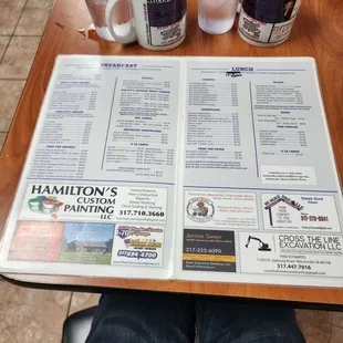 a menu and two cups of coffee