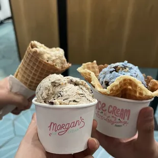 two people holding ice cream cones
