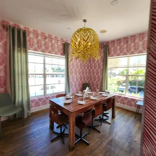 a dining room with a table and chairs