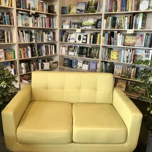 a yellow couch in a library