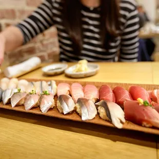 My friend enjoying her Omakase At Table ($250 / person) sushi course for 3