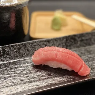 a sushi on a plate with chopsticks