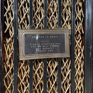 a sign on a metal gate