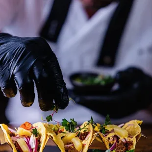 a chef preparing tacos at a restaurant