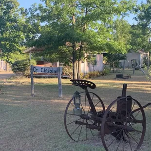 Cabins and 19th century settlers farm equipment
