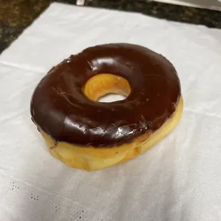  a chocolate frosted donut on a napkin