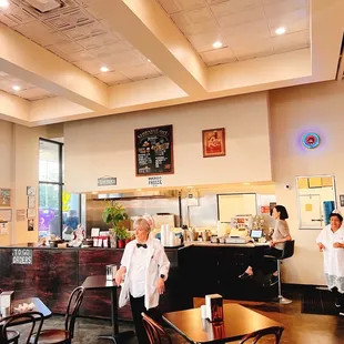 two people standing in a coffee shop