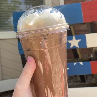 a hand holding a cup of coffee
