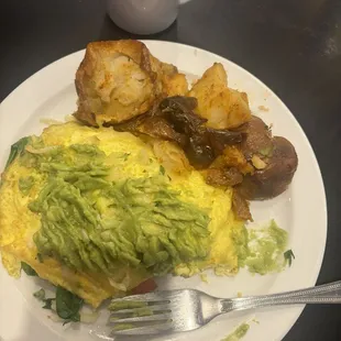 Aspen omelet with tomatoes, spinach and white cheddar cheese.