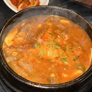 a bowl of soup and a plate of vegetables