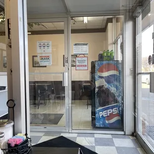 the front entrance of a pepsi store