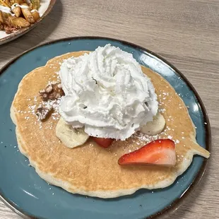 One pancake with banana and strawberries