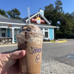 a hand holding a cup of coffee
