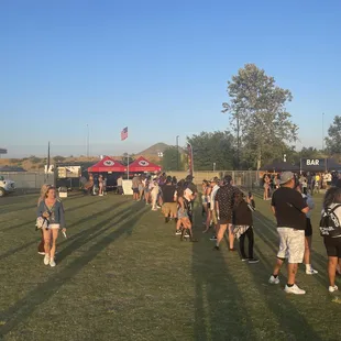 a crowd of people standing in a field