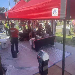 a group of people under a red tent