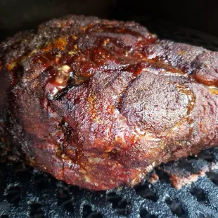a pork roasting on a grill