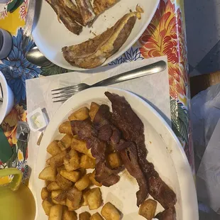 Poached eggs, crispy bacon, American fries, and French toast. Sorry I already ate some!