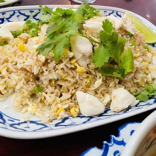 a plate of fried rice and vegetables