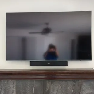 Custom fireplace TV mount with wire concealment