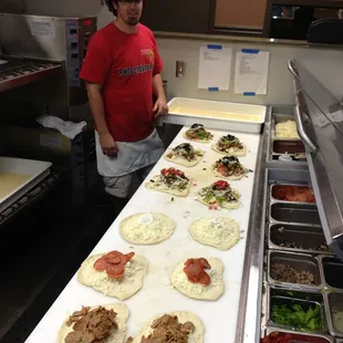 Preparing a large order of fresh Calzones