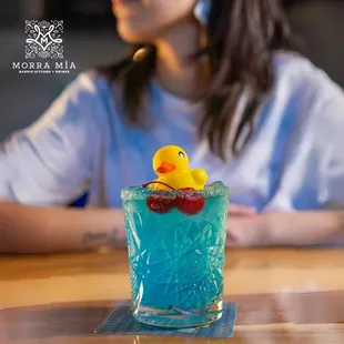 Drinks con Madre
Coconut Rum + Hpnotiq + Blue Curacao + Fresh Lime Juice + Lemon Lime Soda. Served with a Little Duck to keep you company