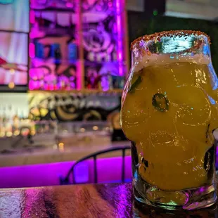 a glass of beer on a bar