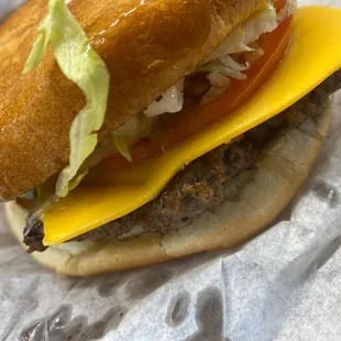 a hamburger with cheese and lettuce
