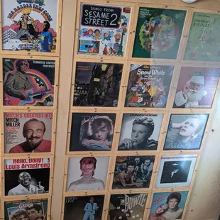 a bathroom with a toilet and various posters on the wall